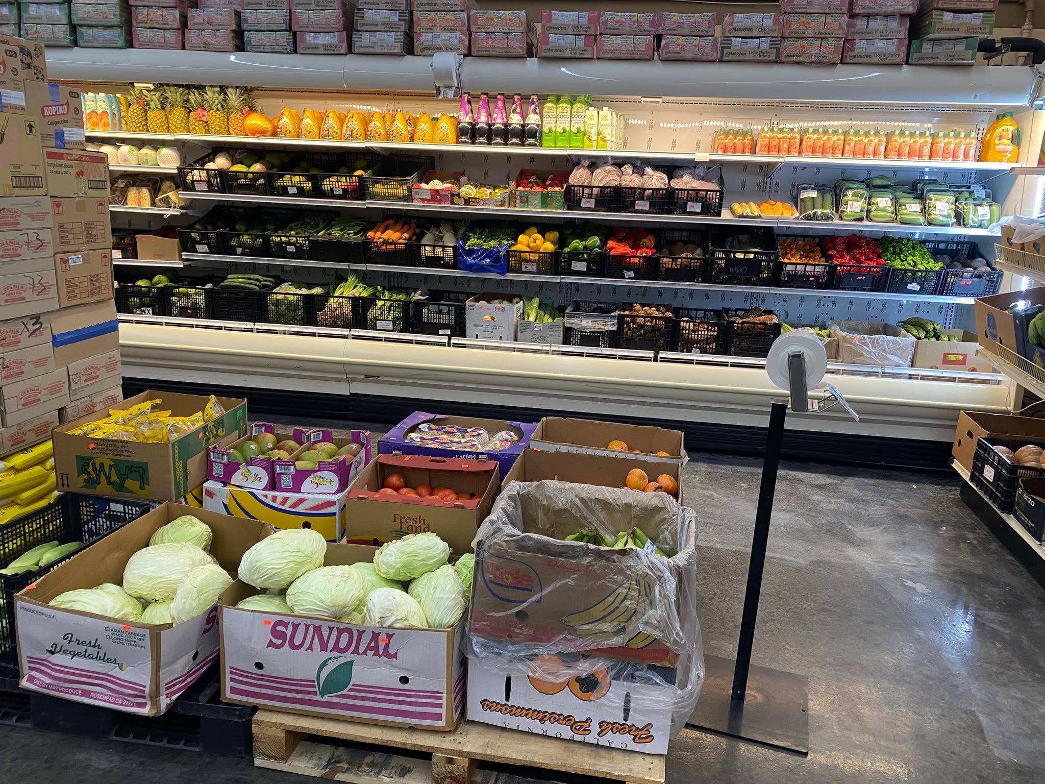 Stocked international grocery aisle inside S International Market