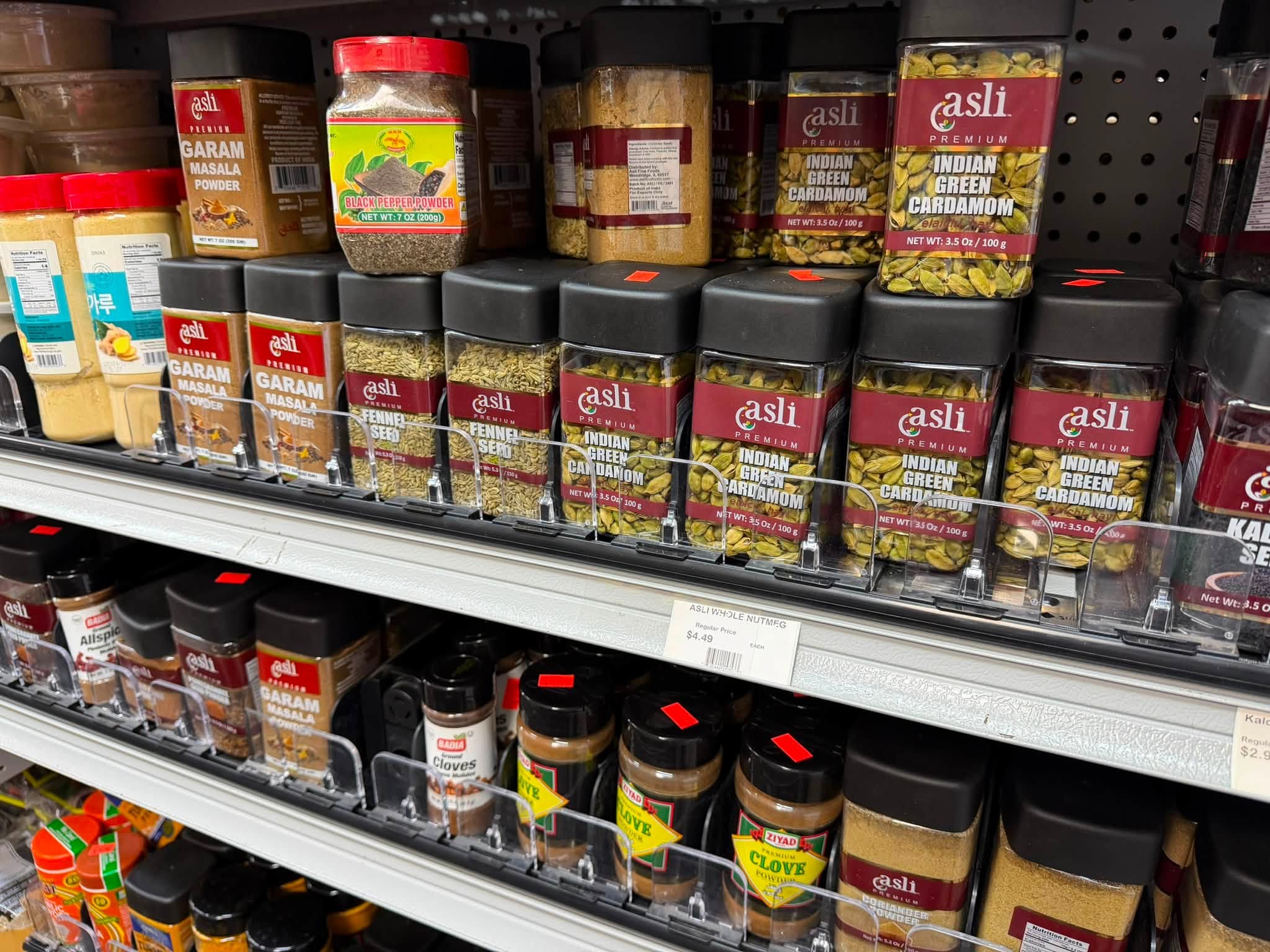 Spices, sauces and pantry products on stocked shelves